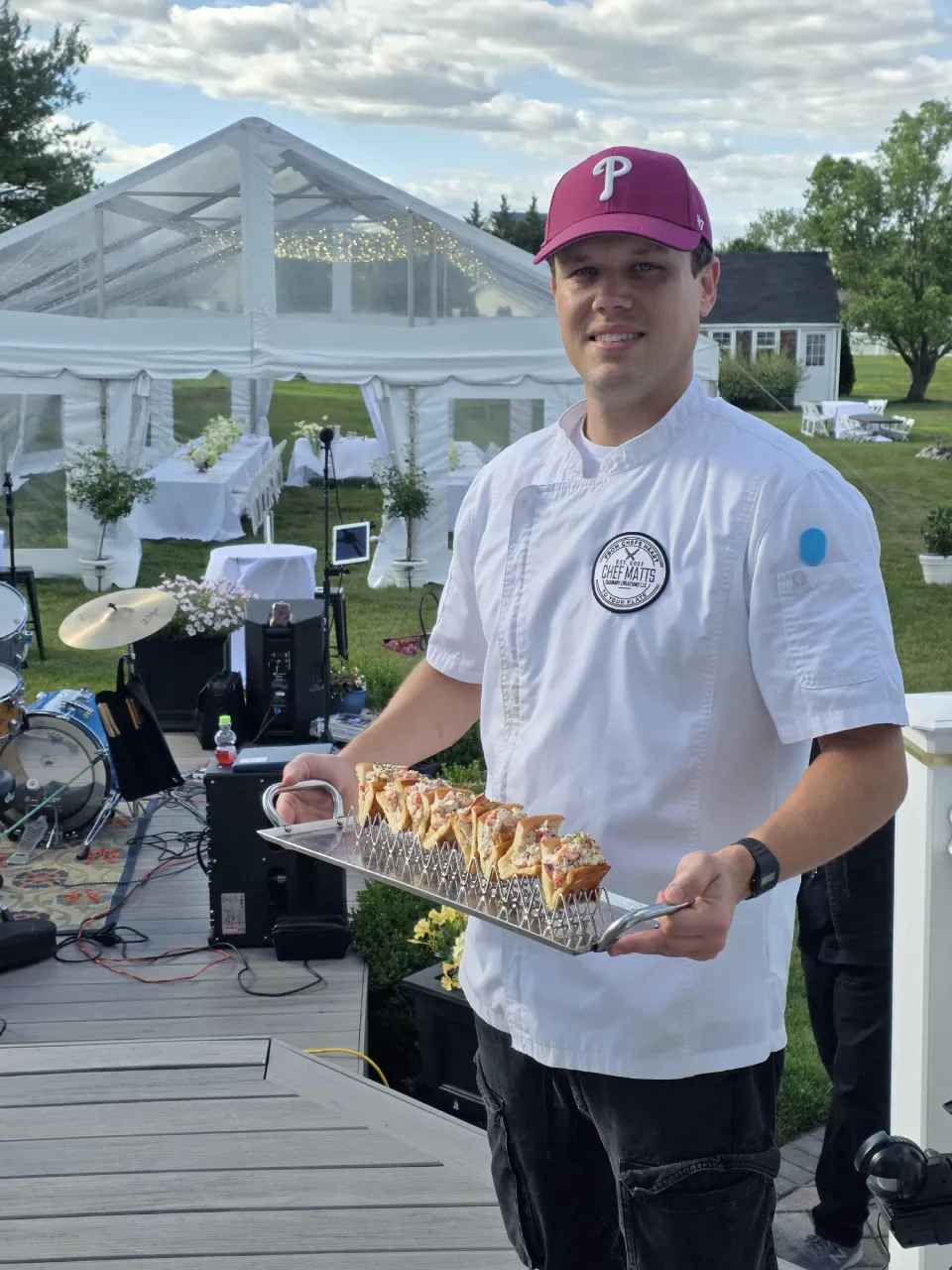 Chef Matt serving passed hors d'oeuvres at an outdoor cocktail party