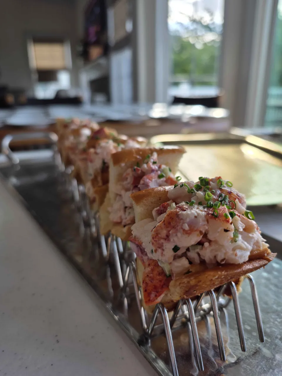 Mini lobster rolls on a silver tray for cocktail party service by Chef Matt