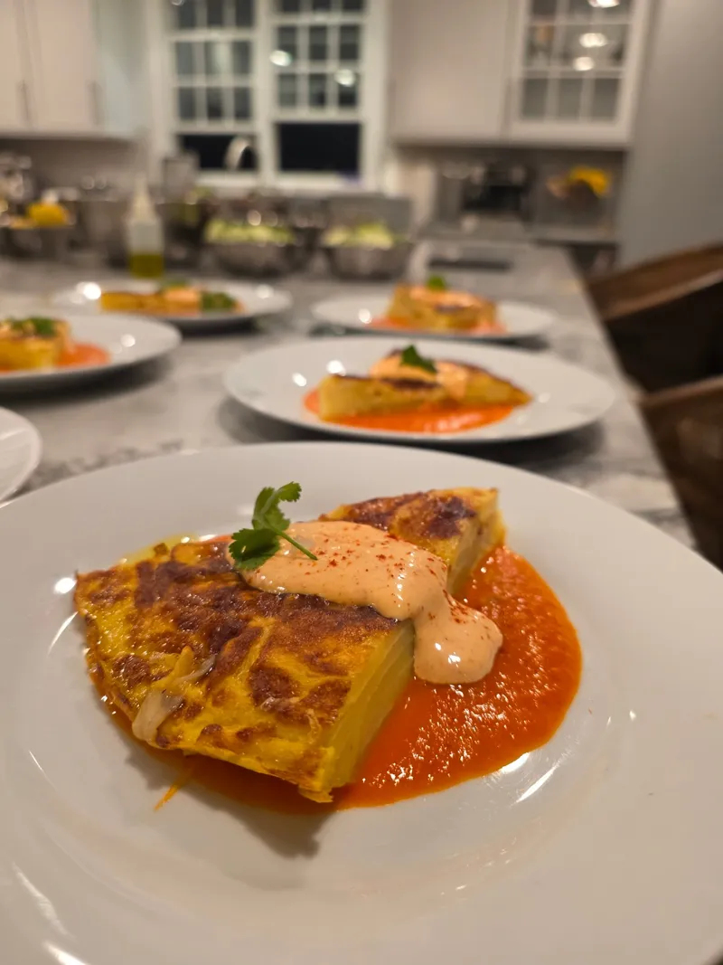 Spanish tortilla with romesco sauce and chipotle aioli plated for a private dinner party